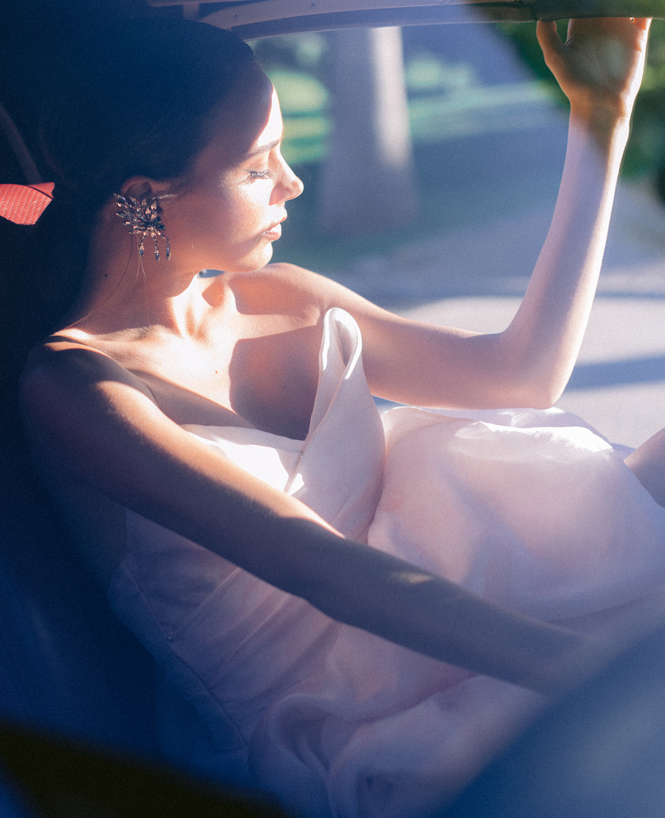Color bridal portrait inside a vintage Jaguar on the French Riviera